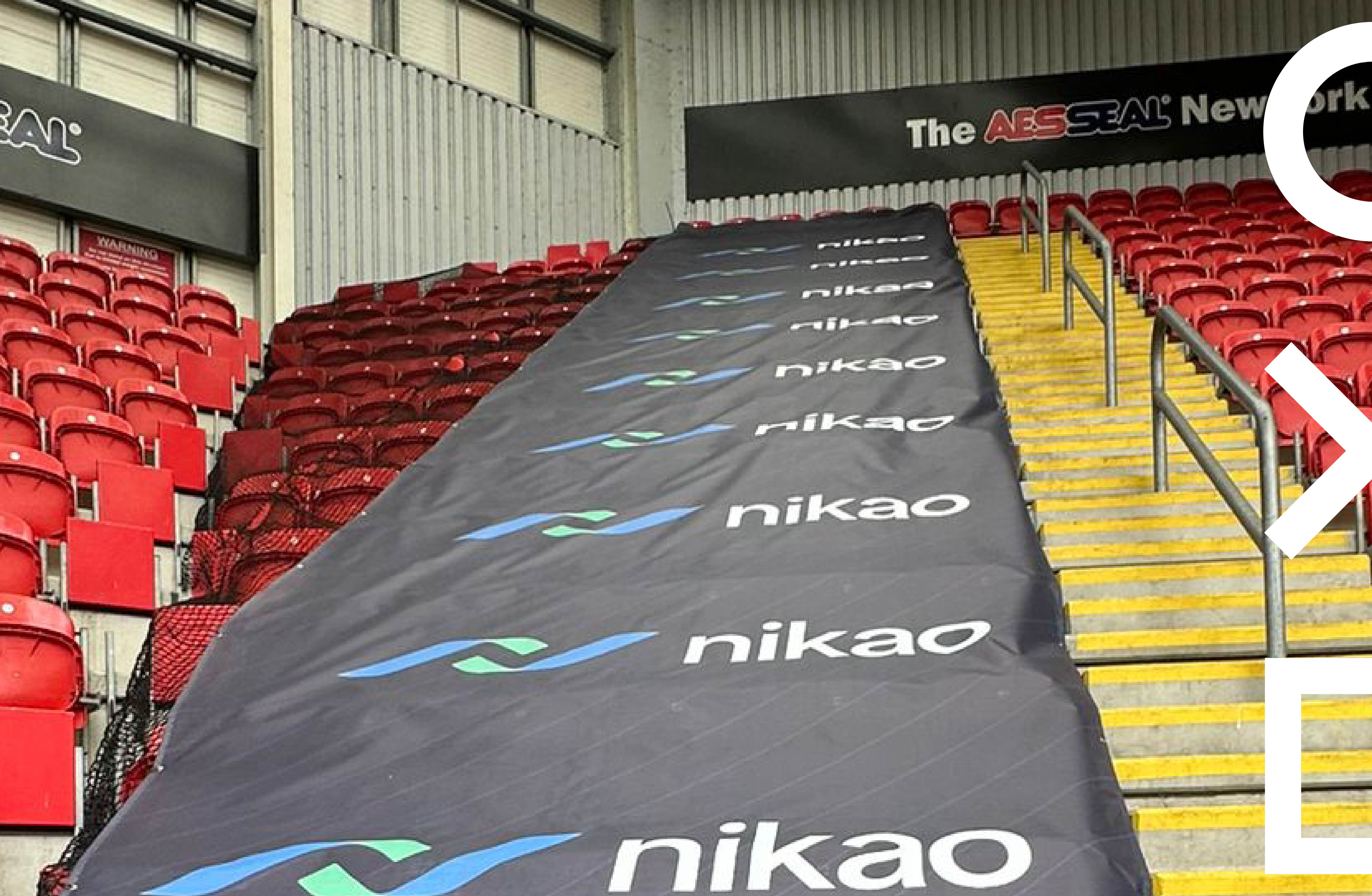 Branded mesh safety barrier banner with Nikao branding at Rotherham United