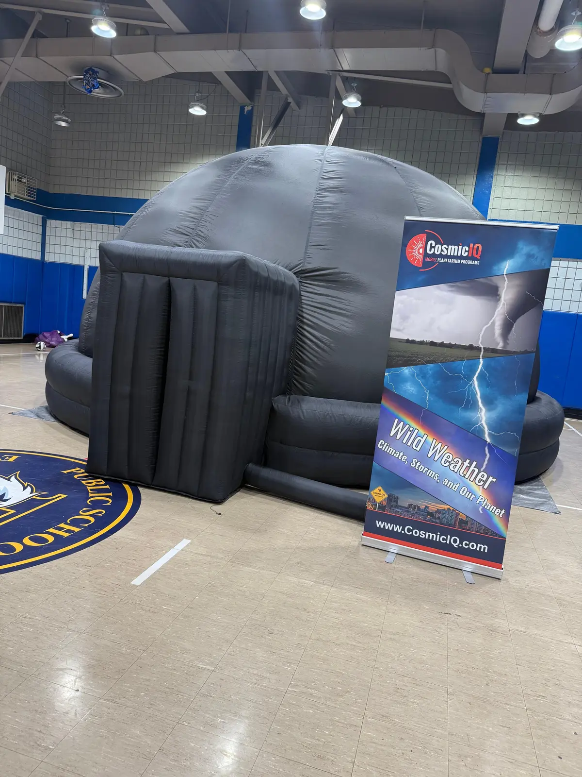 Inflatable planetarium dome in school gymnasium