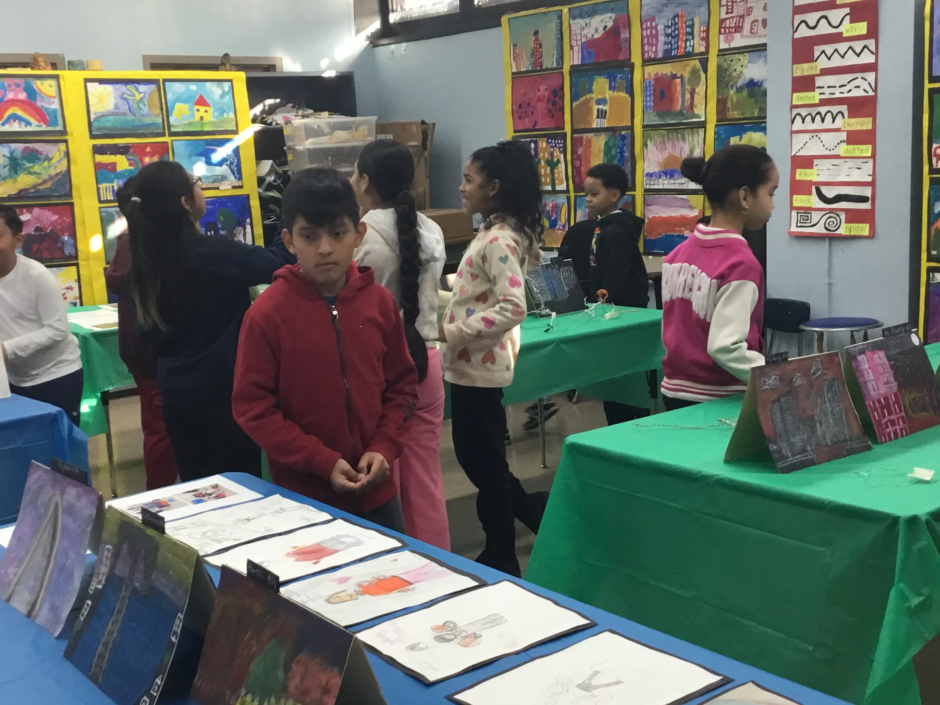 Students viewing artwork at school art exhibition