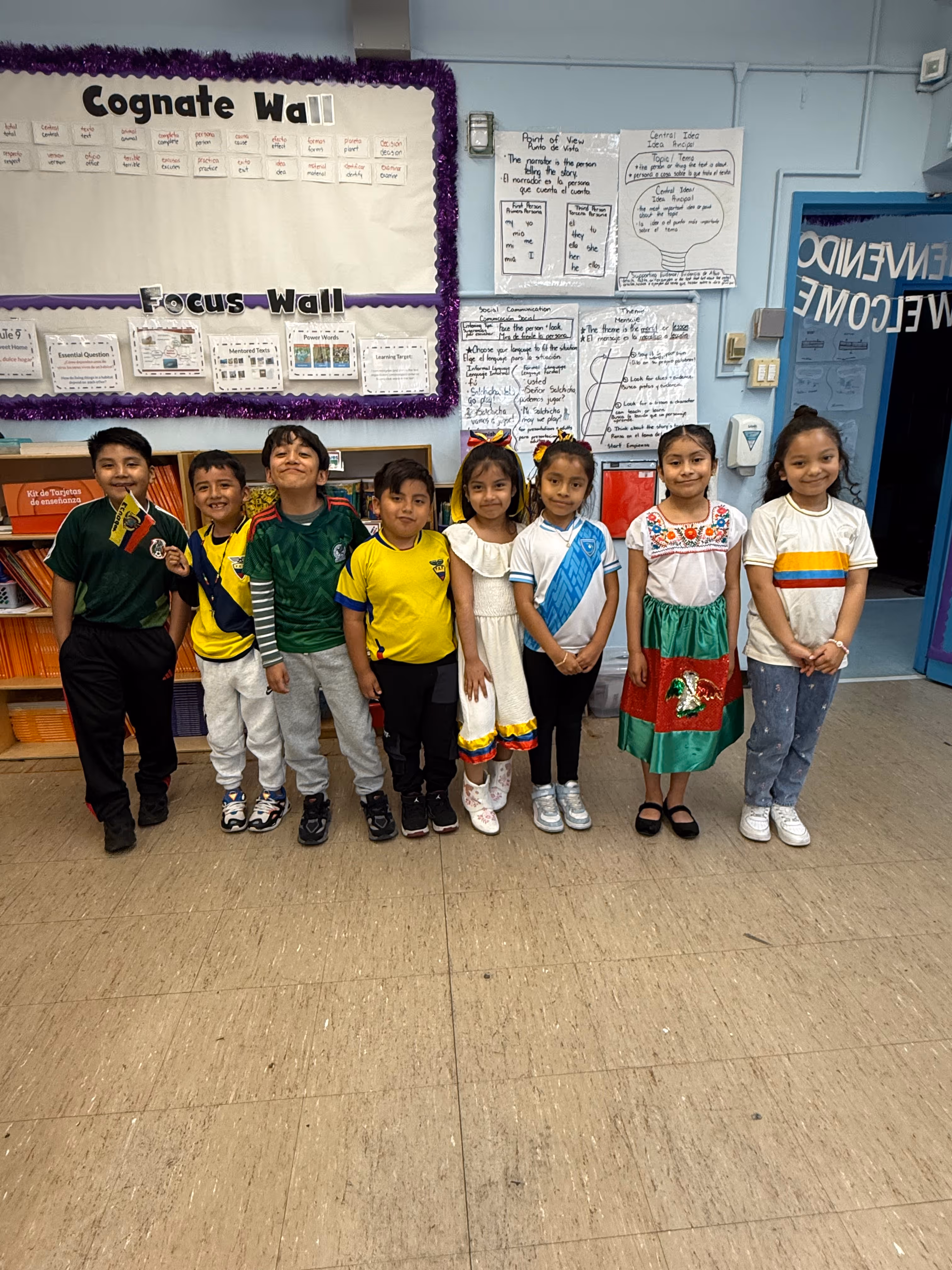 Students wearing Latin American cultural attire pose in classroom