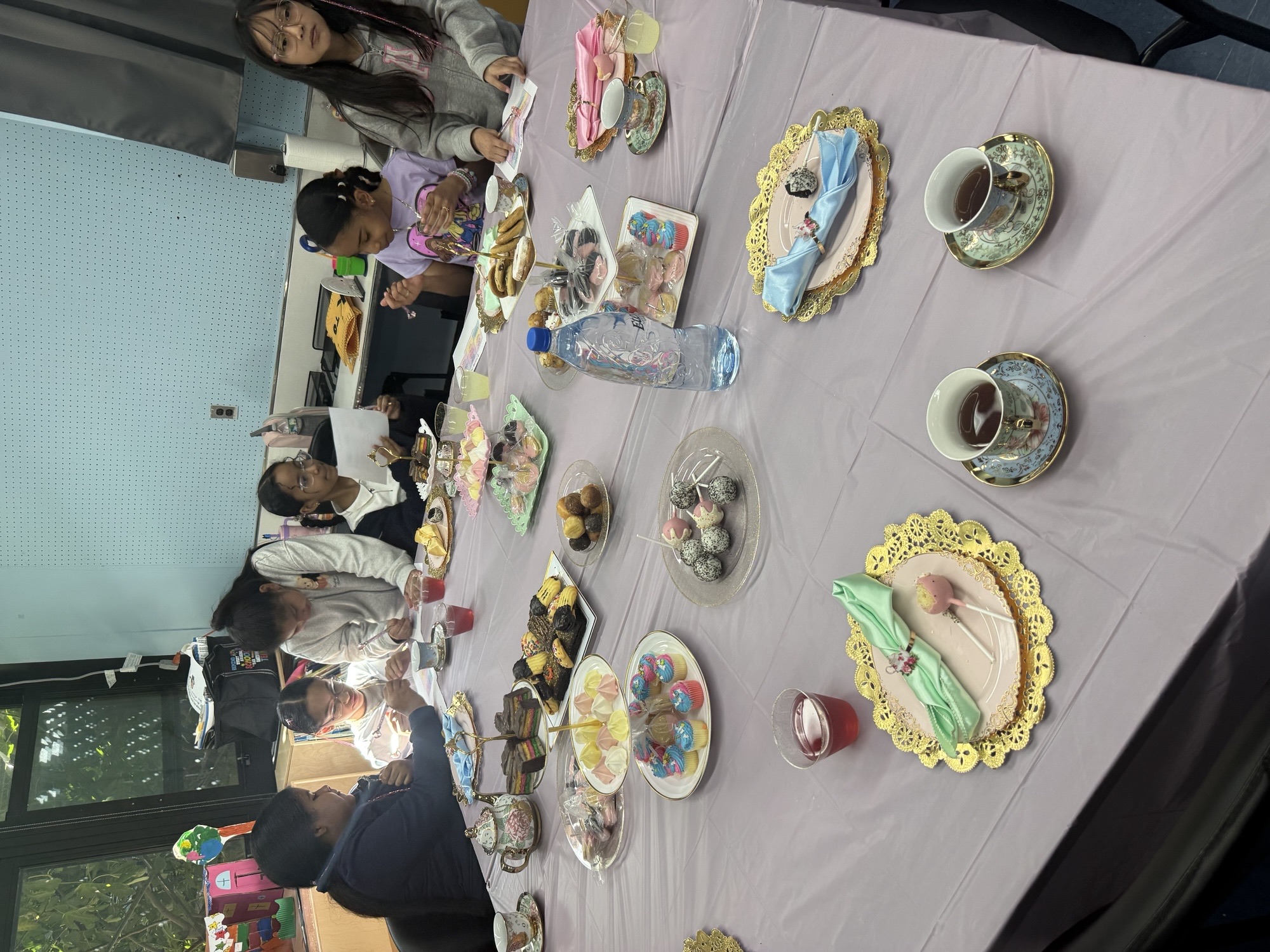 Teacups and desserts set out for the International Girls Day tea party