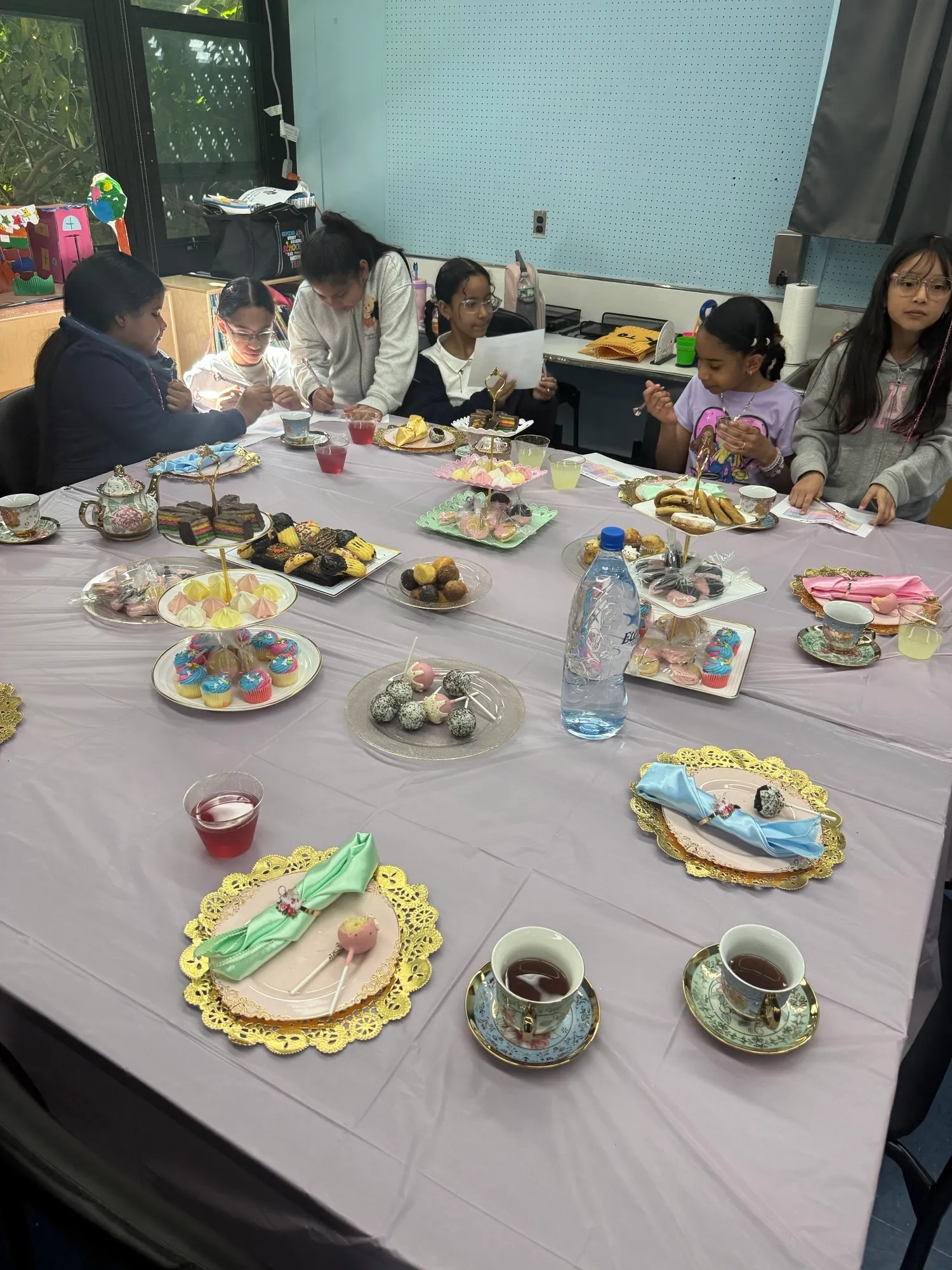 Teacups and desserts set out for the International Girls Day tea party