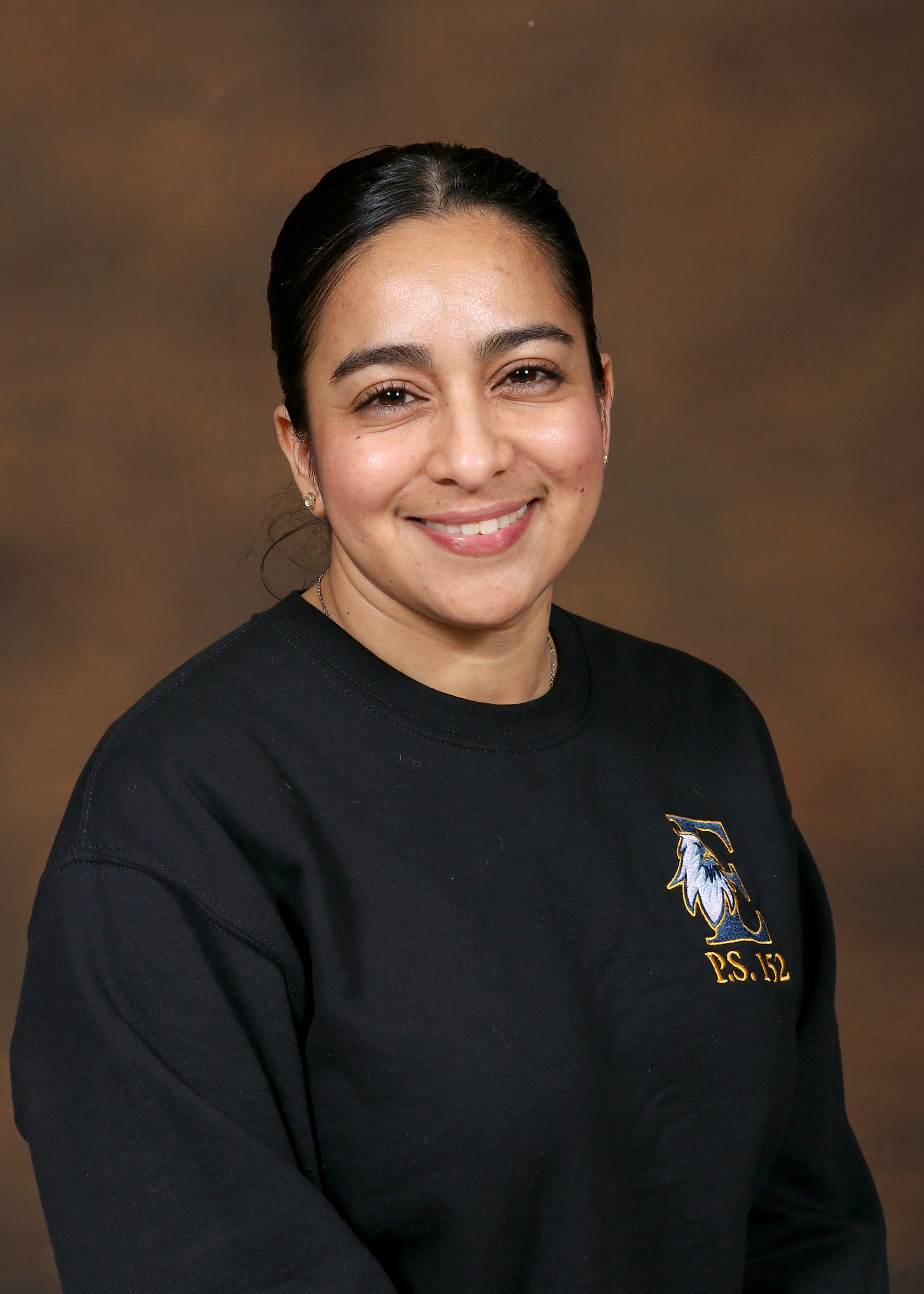 Staff member Ms. Prudencio wearing a PS 152 school sweatshirt