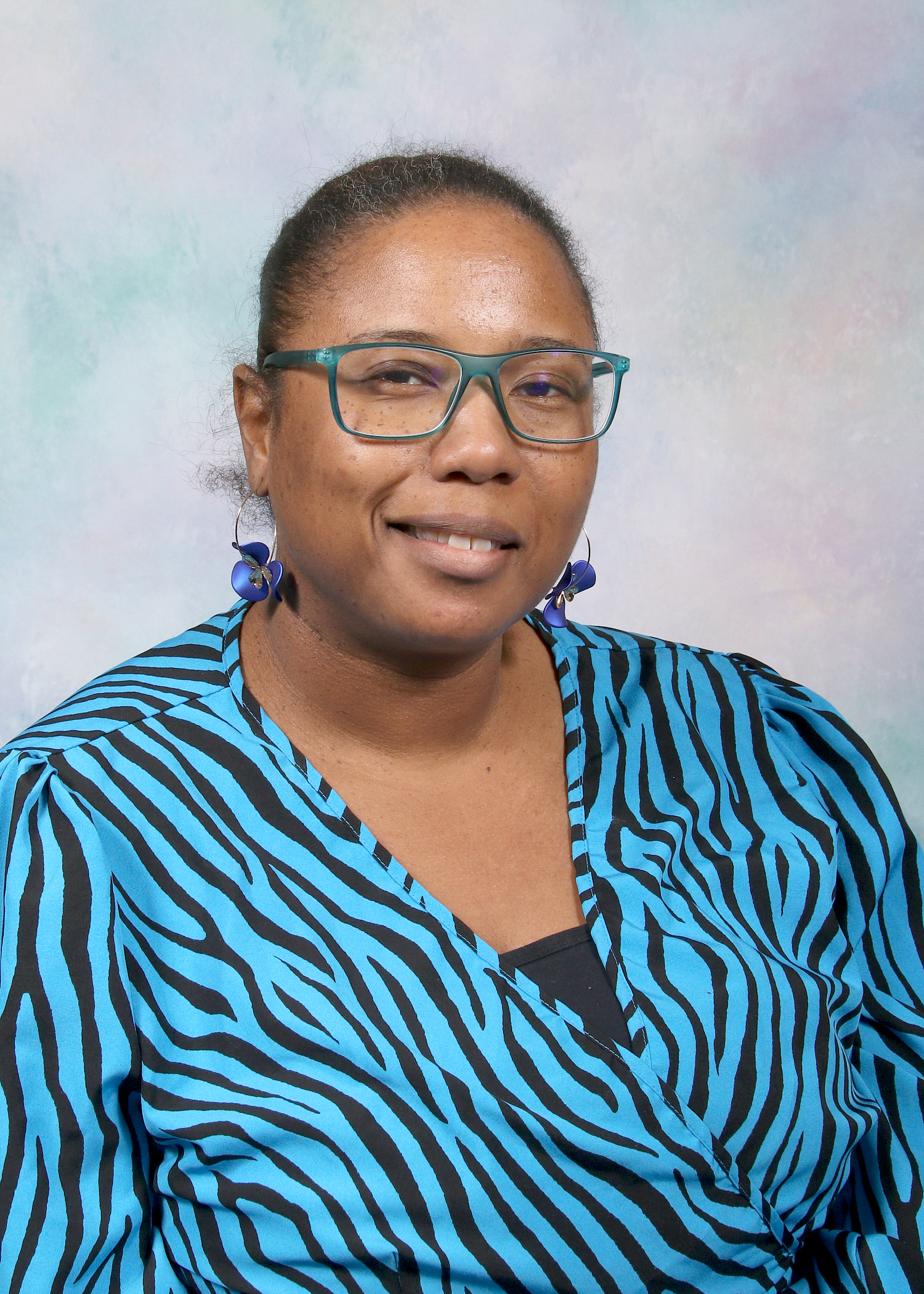 Ms. Willis smiling in a staff directory portrait photo