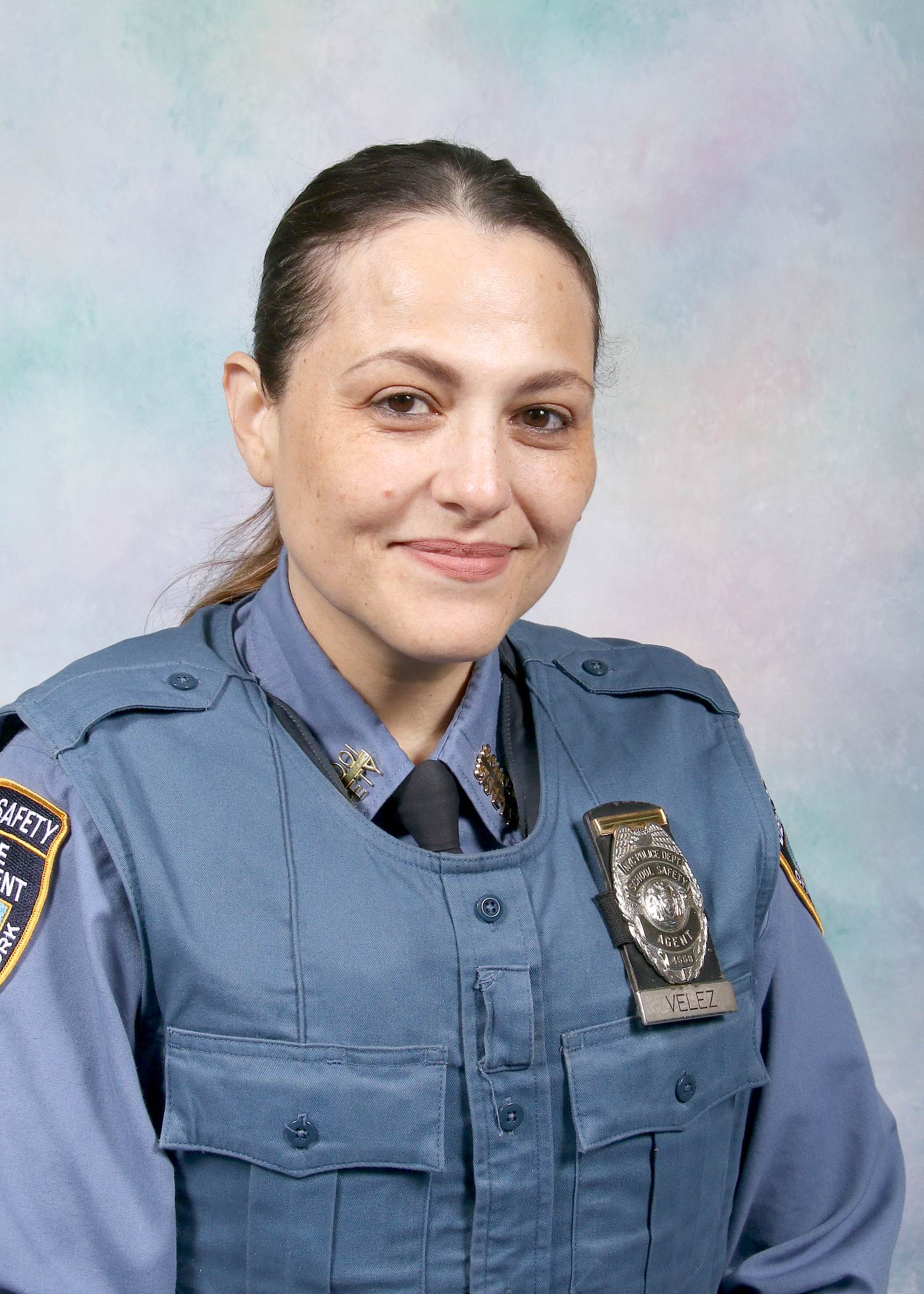 School Safety Agent Ms Yanira Velez in uniform with badge