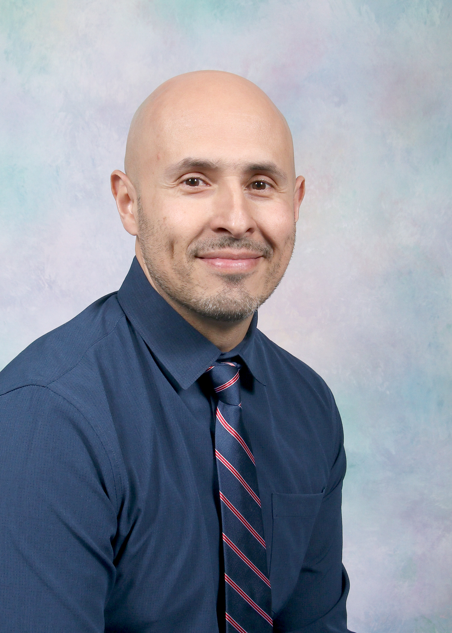 Mr. Rincon smiling in a professional staff portrait photo
