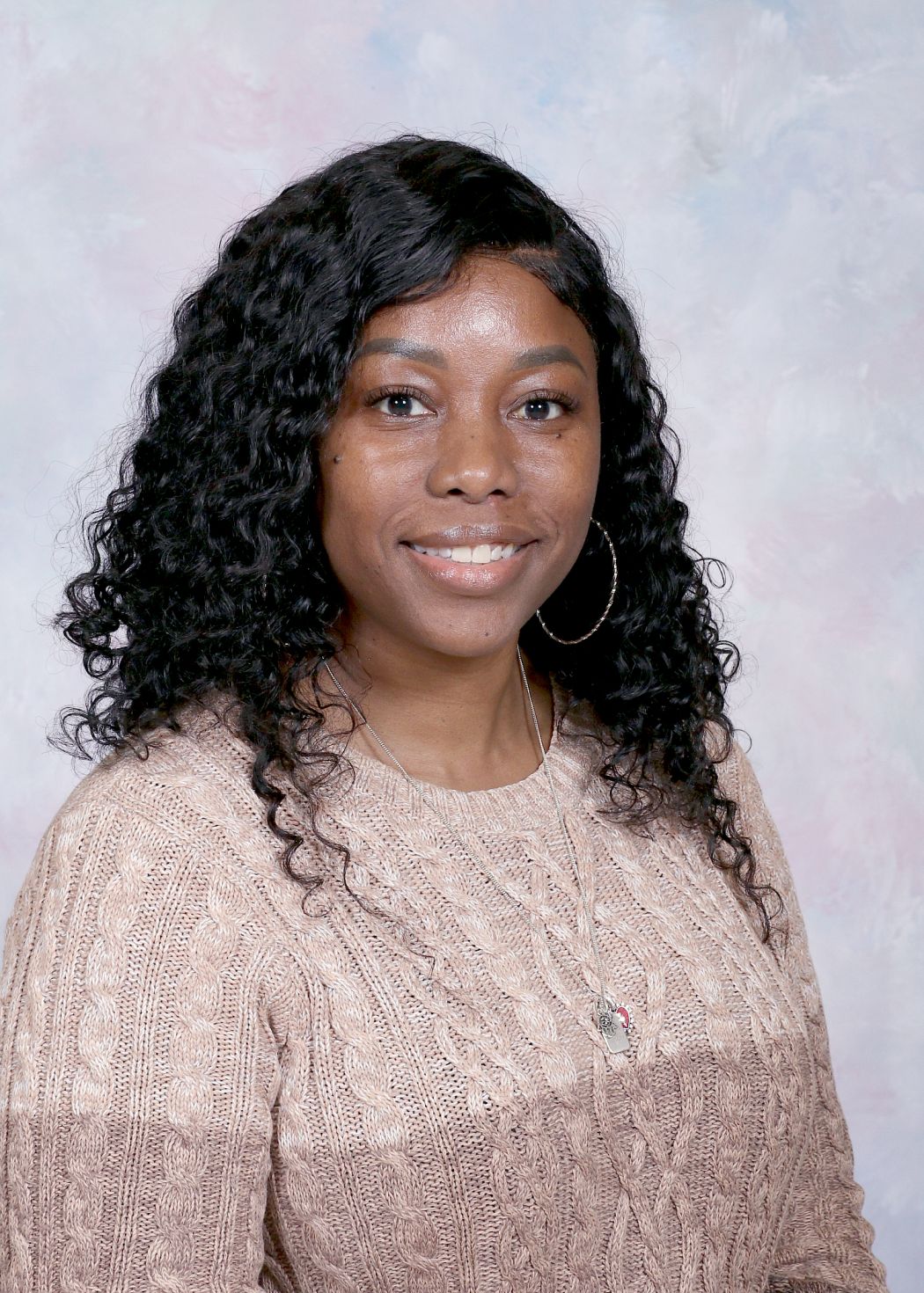 Ms. Pastor smiling in official school staff portrait photo