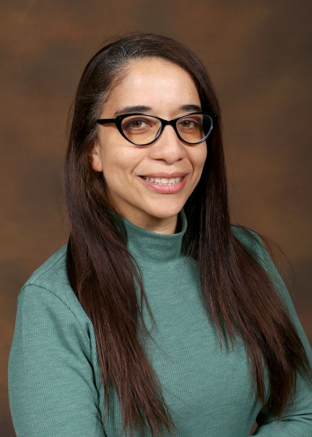 Ms. Cosma smiling in a professional staff directory portrait