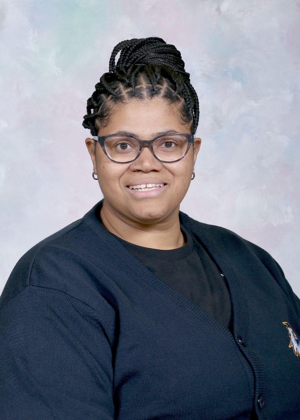 Ms. Garcia staff portrait photo smiling in school cardigan