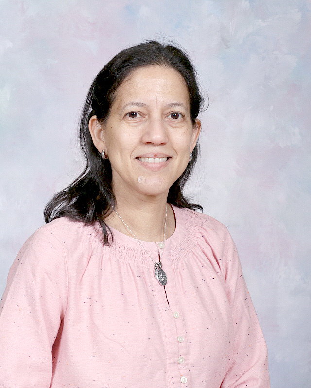 Ms. Cueto smiling in a professional staff portrait photo
