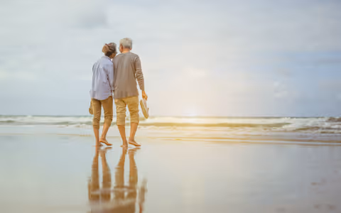 Couple walking down beach