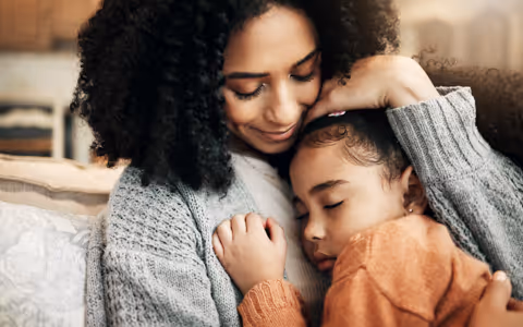Image of Happy mother holding daughter
