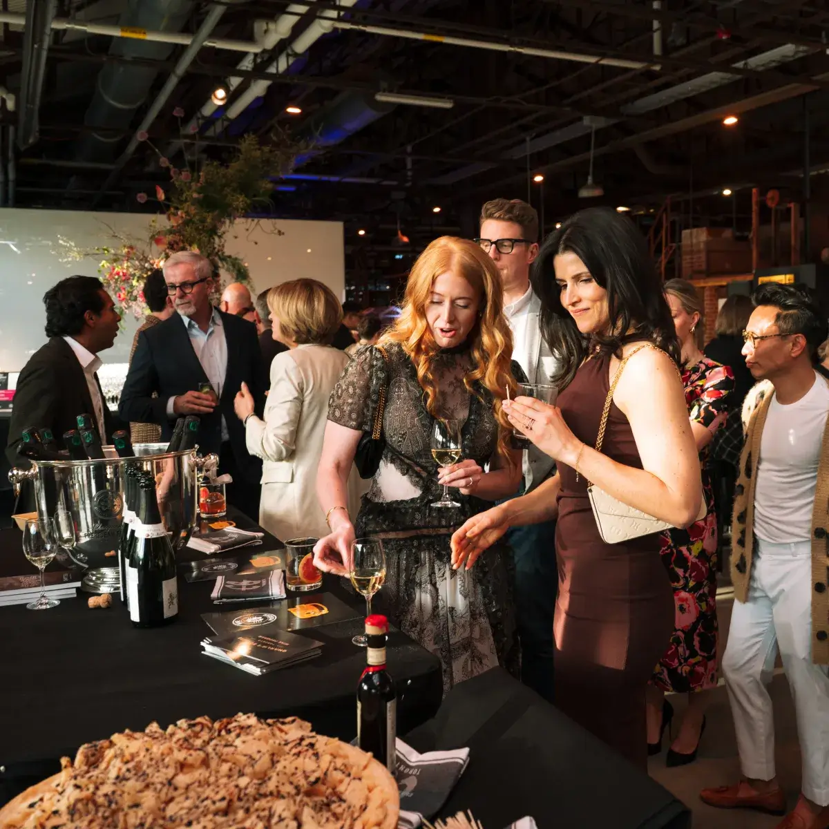 A crowd of people sampling food at the Chefs for Change event.