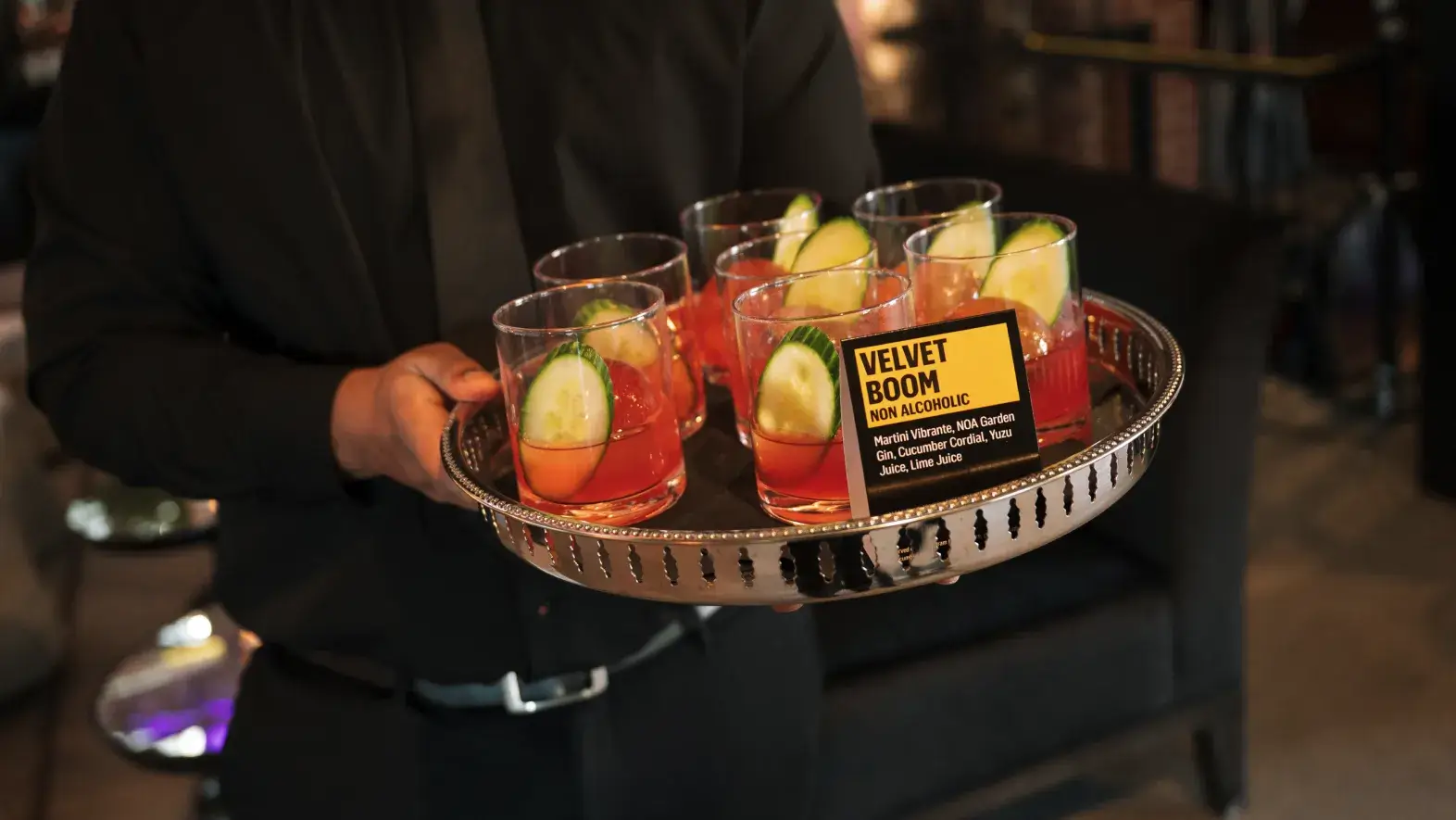 Server carrying non alcoholic drinks tray 