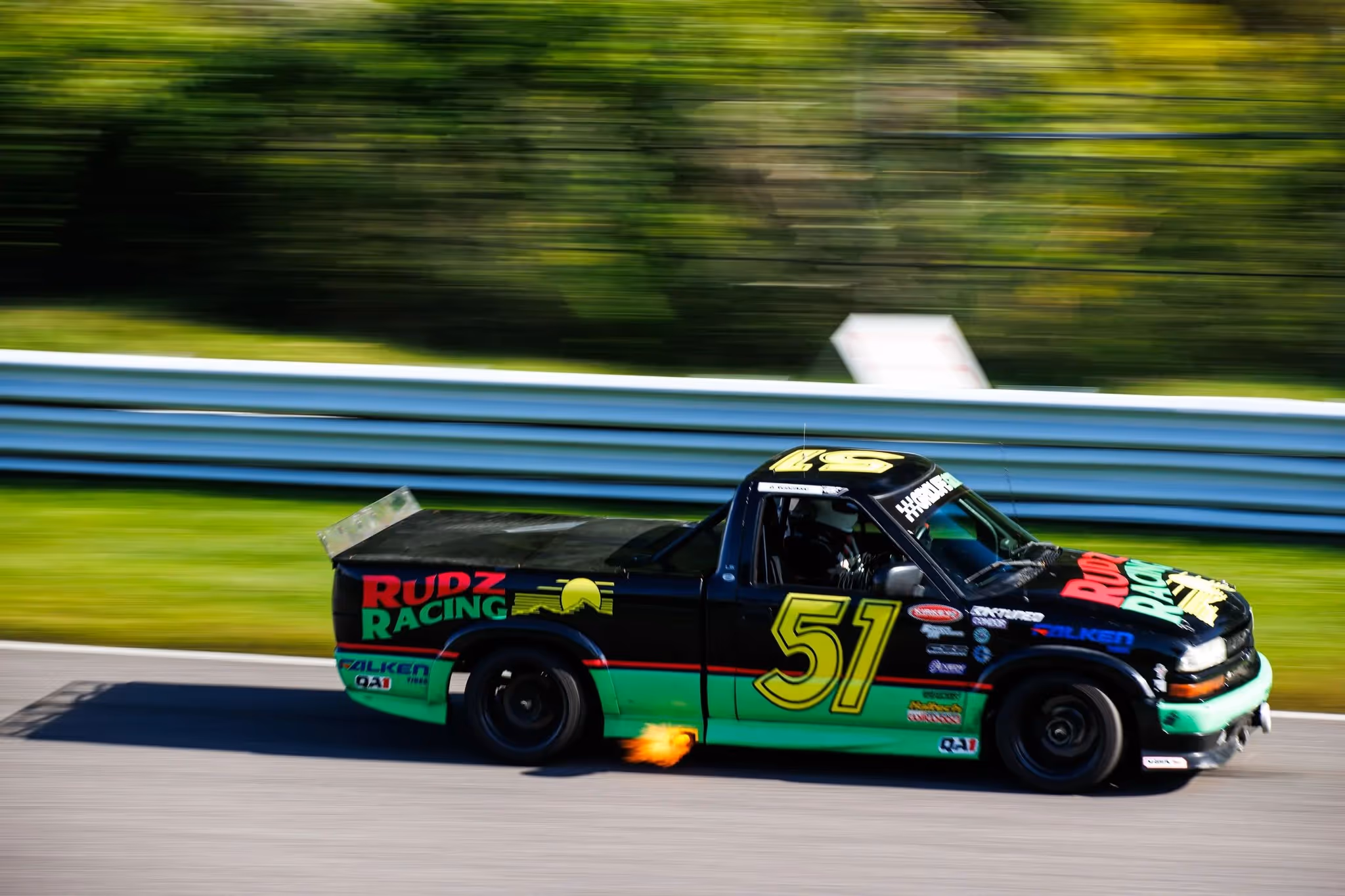a race truck on the track, number 51.
