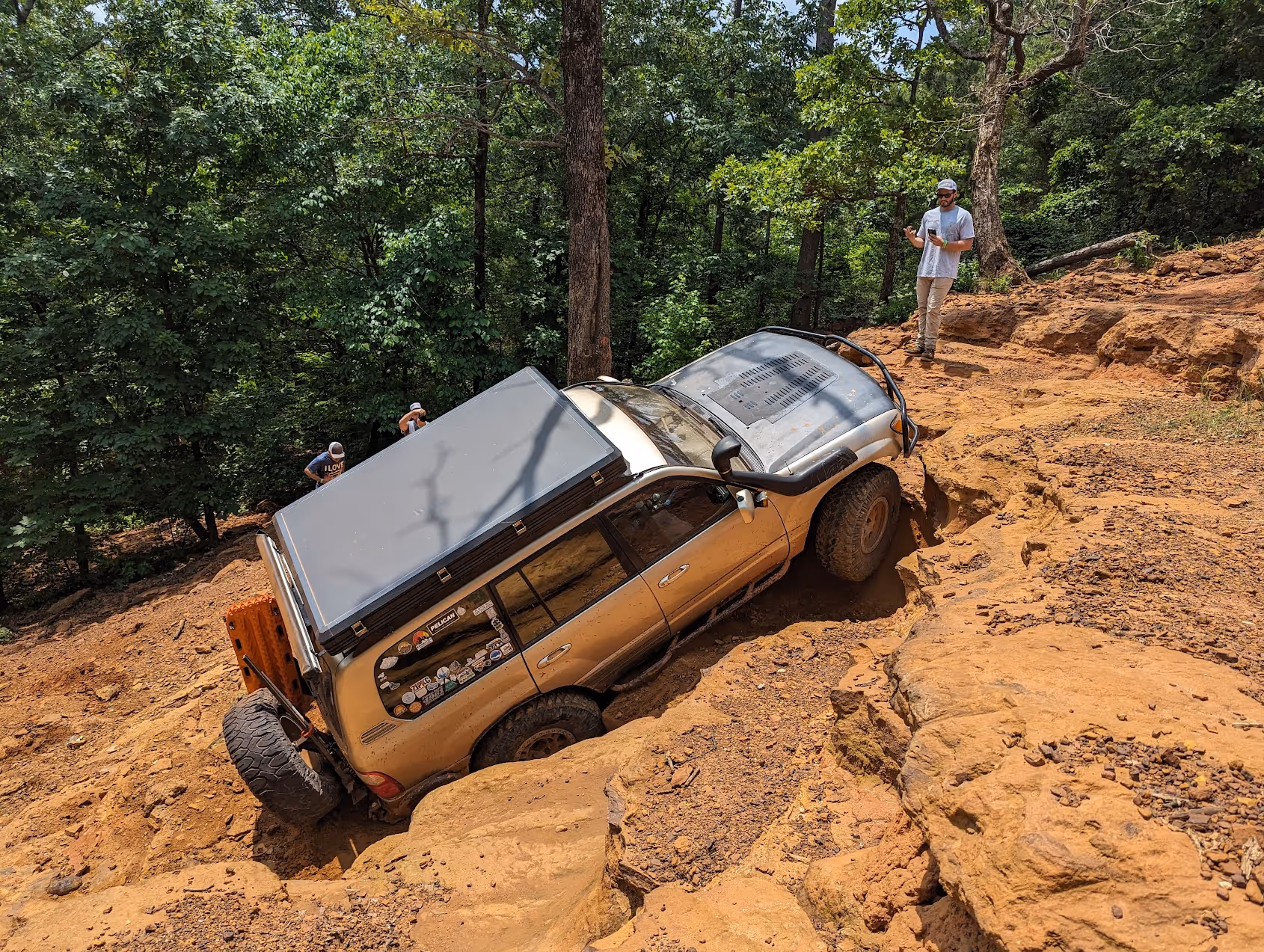 a toyota truck rock crawling up a rough hill
