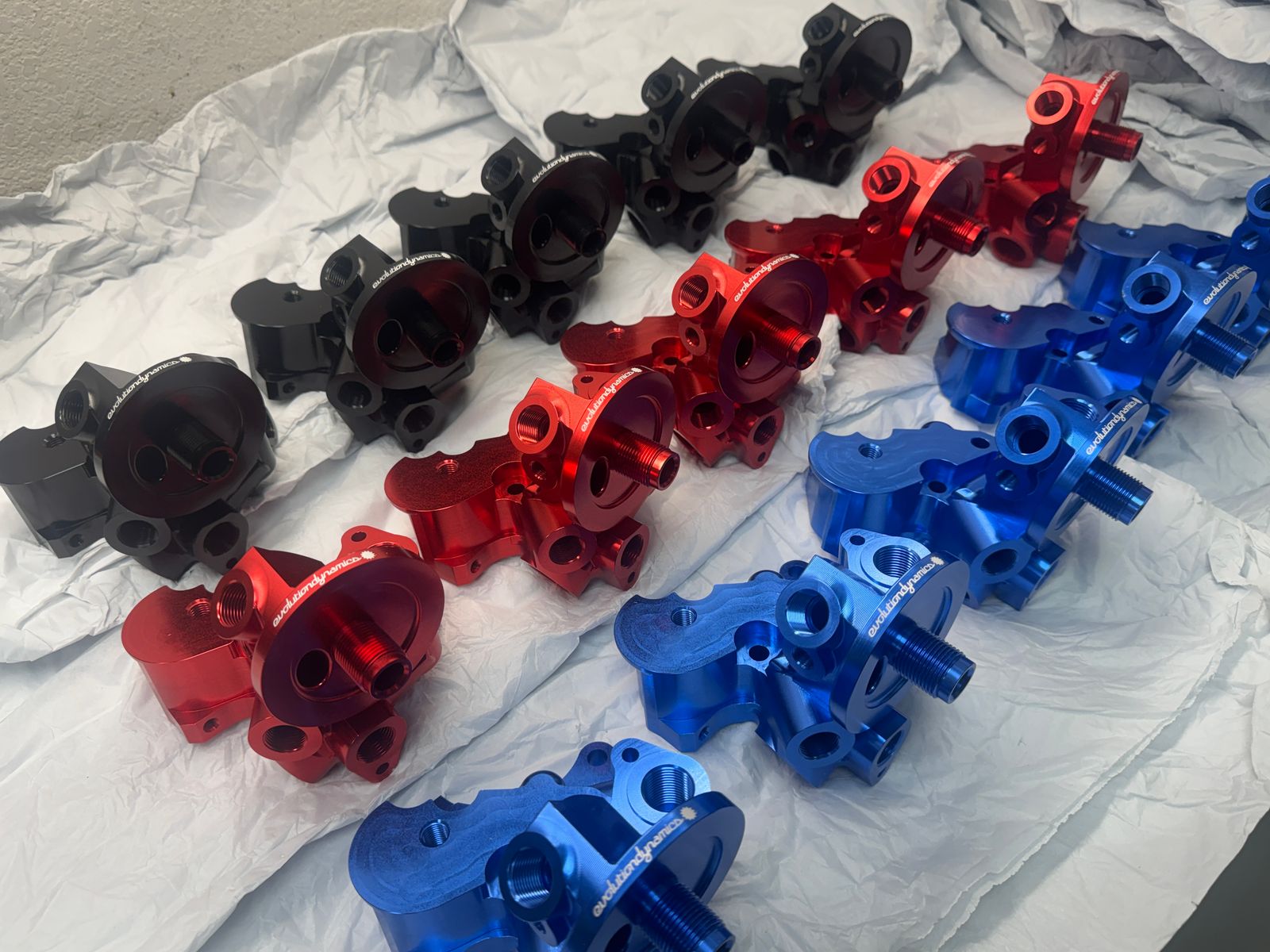 Rows of freshly anodized billet parts in black, red and blue