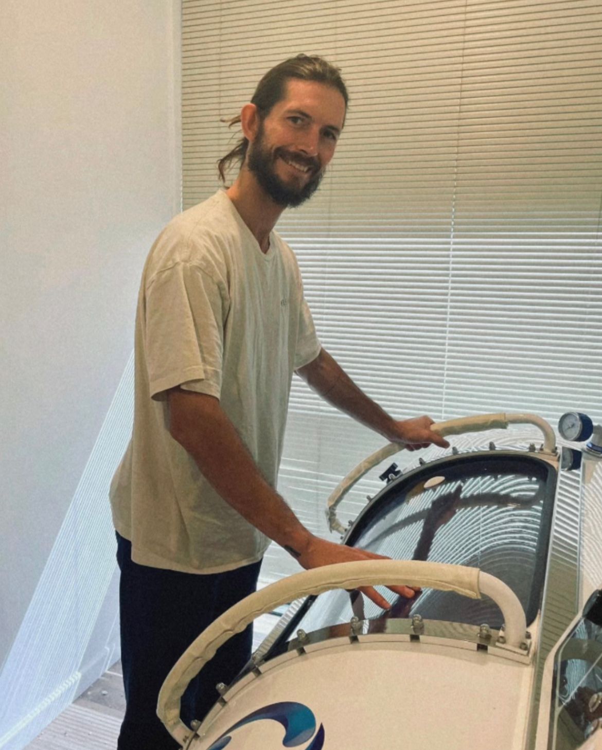 Luca beside a hyperbaric chamber.