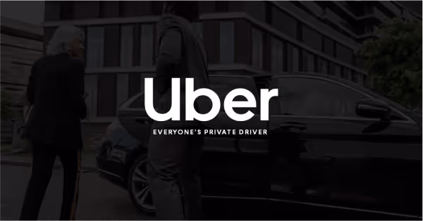 Two people standing beside a black luxury car with the white Uber logo and tagline 'Everyone's Private Driver' overlaid.