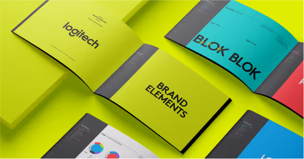 Open Logitech brand guideline book showing pages titled BRAND ELEMENTS and BLOK with charts and colorful sections on a bright lime green background.