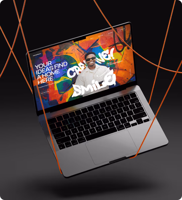 Open laptop displaying a colorful website with the text 'Your ideas find a home here' and a smiling man wearing sunglasses.