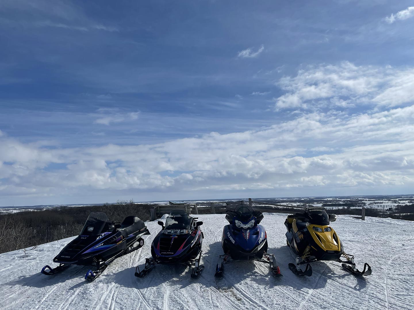 Data Trail four snowmobiles parked