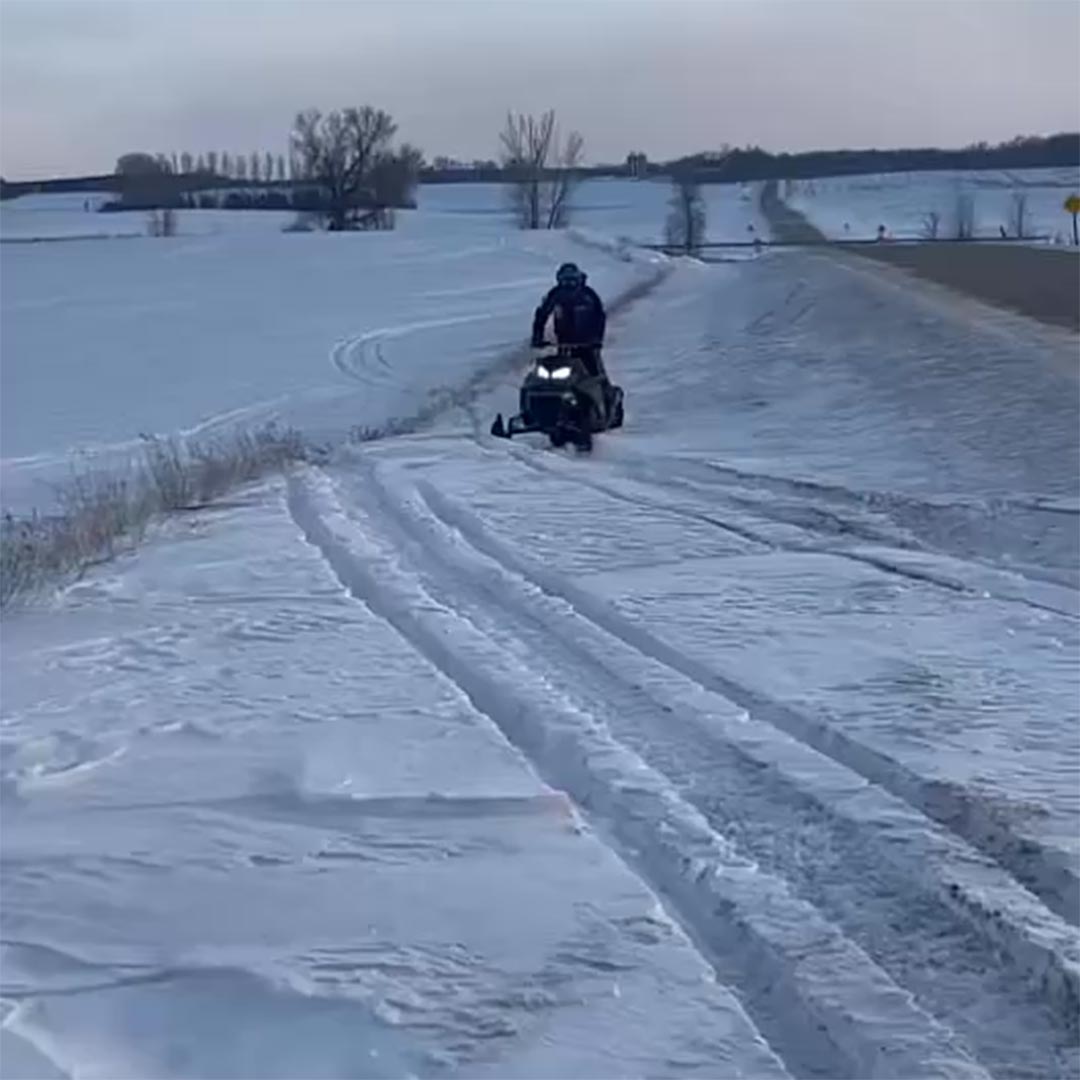 Data trail snowmobile in road ditch