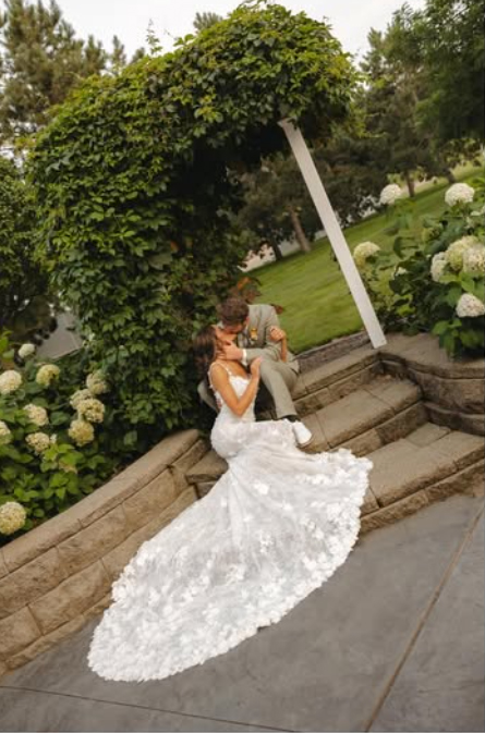 flowing white wedding dress bride and groom in garden