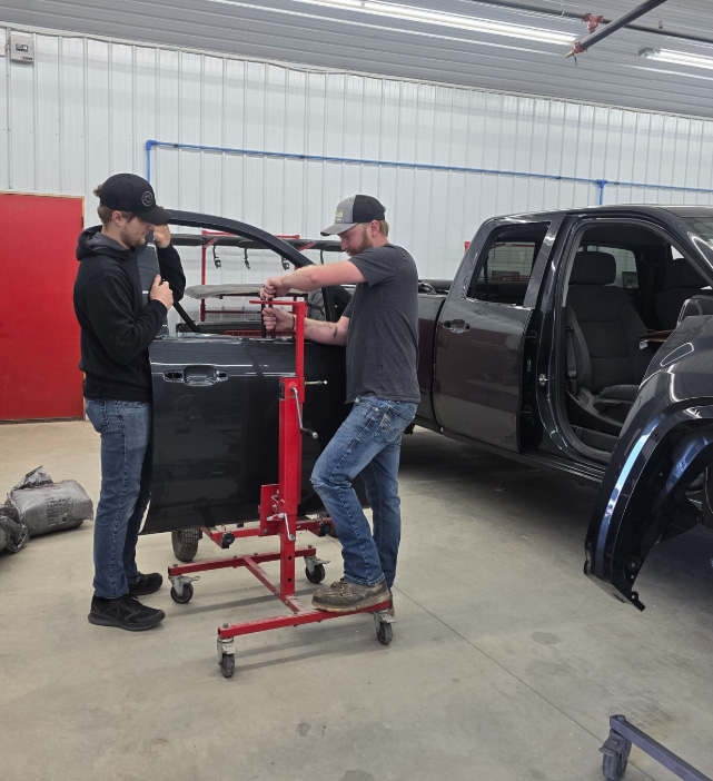 Northside Collision staff straightening door frame