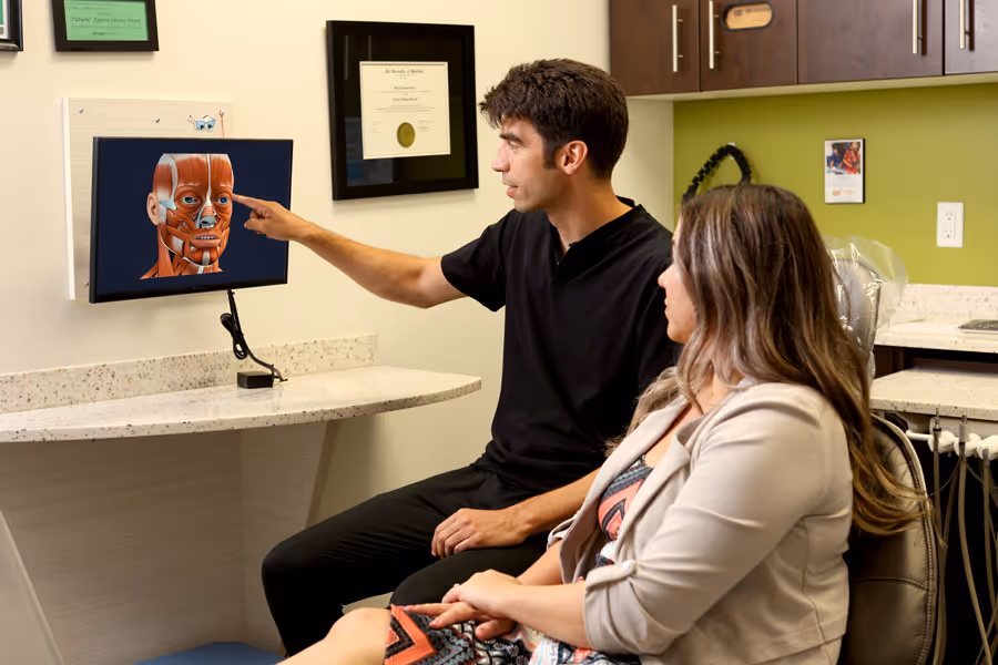Dr. Porco showing the face anatomy to the patient