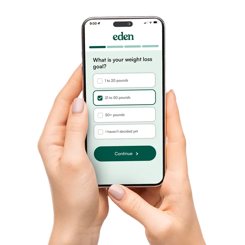 A woman's hand holding a phone completing an online survey