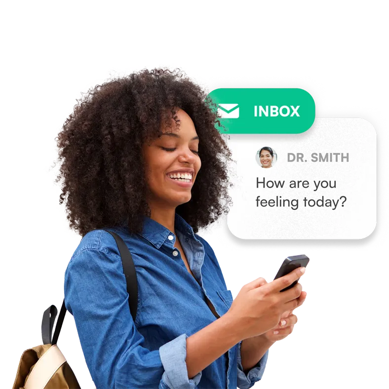 A woman happily looking at a message from her doctor on her phone