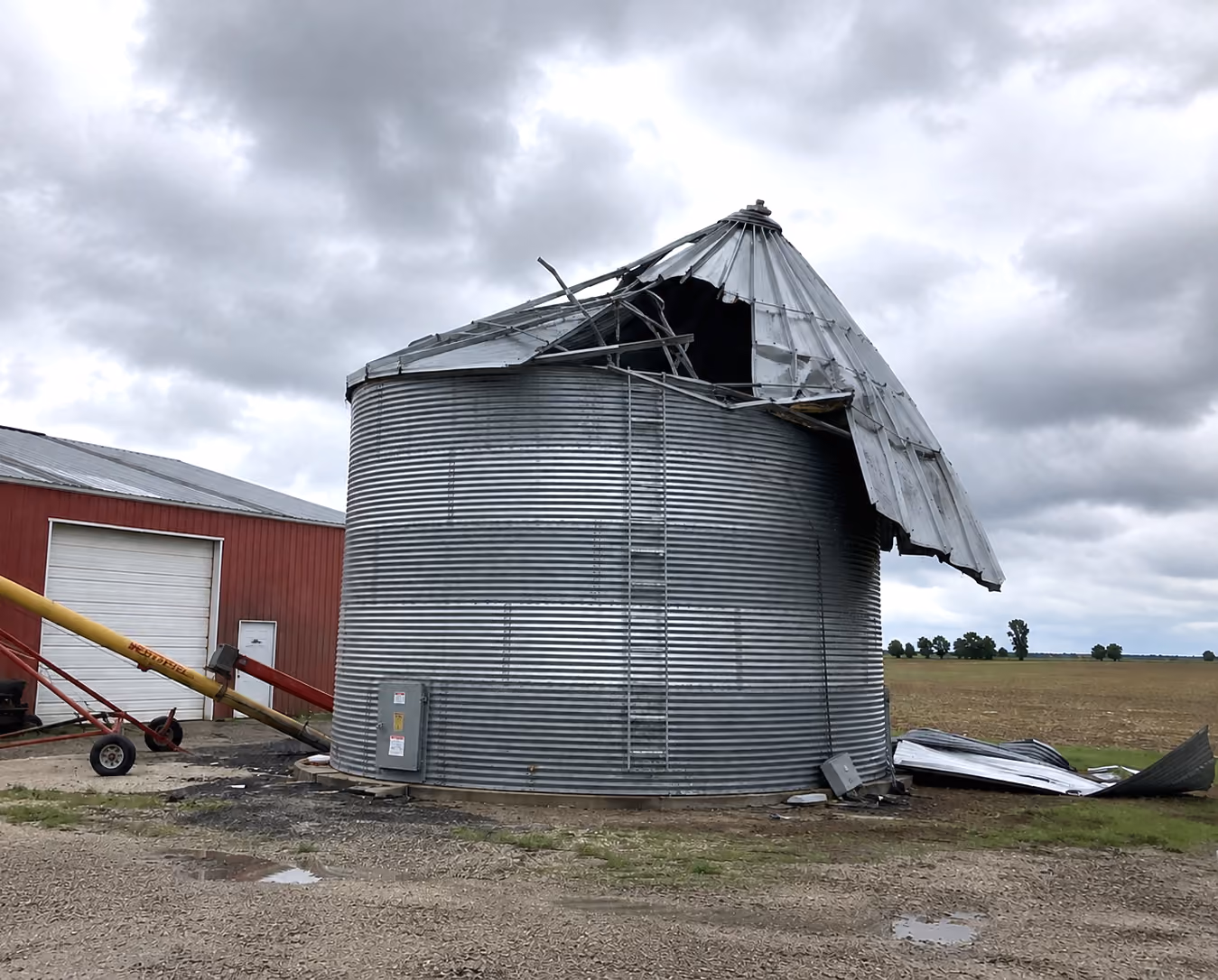 Farm grain bin with wind and storm damage in Iowa