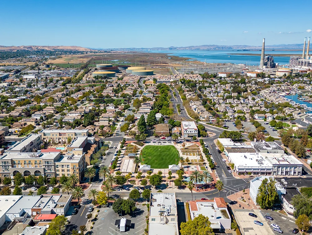 Aerial photo over downtown Pittsburg, California with a refinery in the background