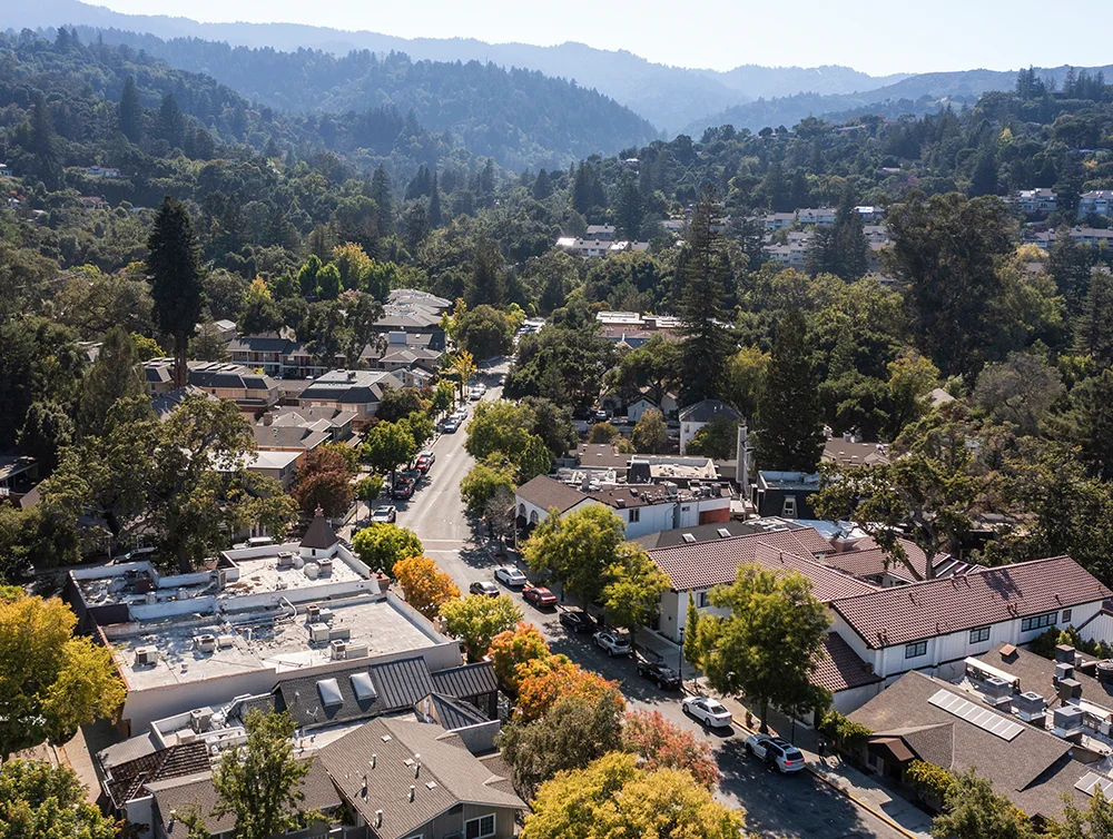 Saratoga, California, USA. Afternoon sun shines on historic downtown buildings and autumn trees.