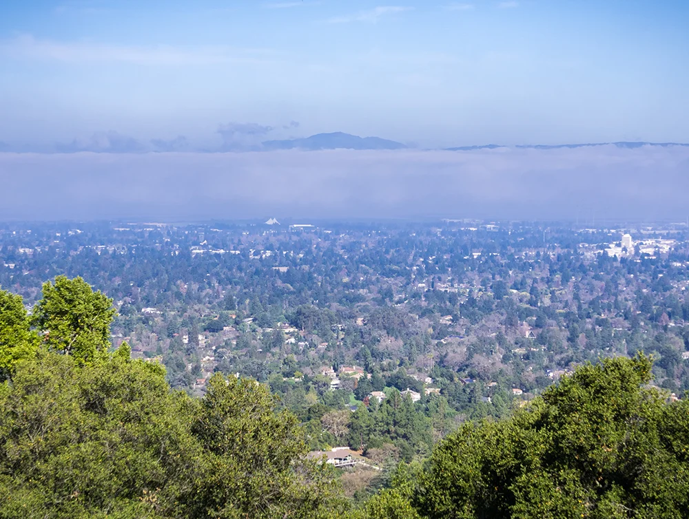 Aerial view of Mountain View and Los Altos covered by a layer of fog, San Francisco bay, California
