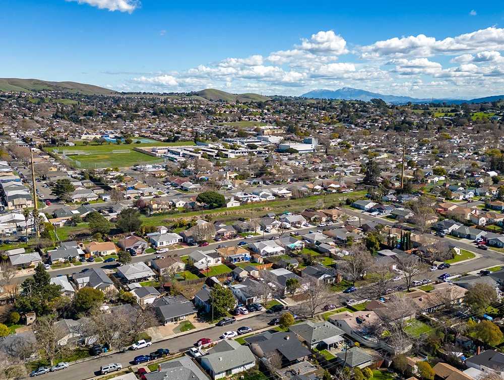 Aerial Photos over a community in Vallejo, California with houses, streets, cars and parks
