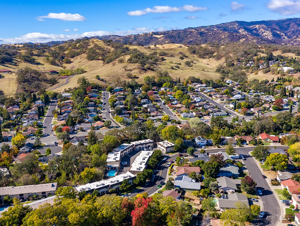 Drone photos over Vacaville, California during the fall with colorful trees and hills