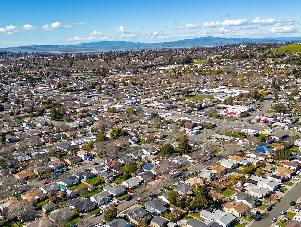 Aerial Photos over a community in Vallejo, California with houses, streets, cars and parks