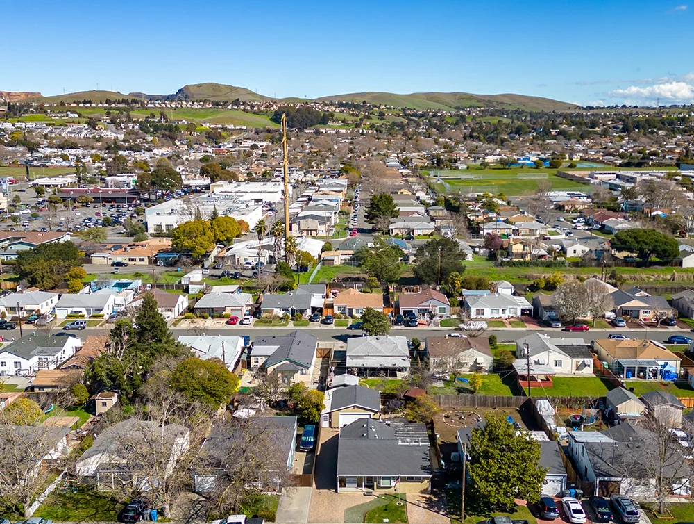Aerial Photos over a community in Vallejo, California with houses, streets, cars and parks