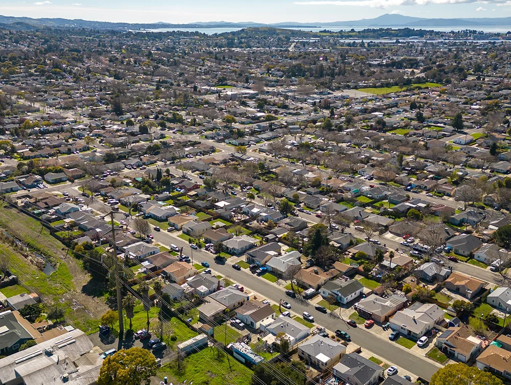 Aerial Photos over a community in Vallejo, California with houses, streets, cars and parks