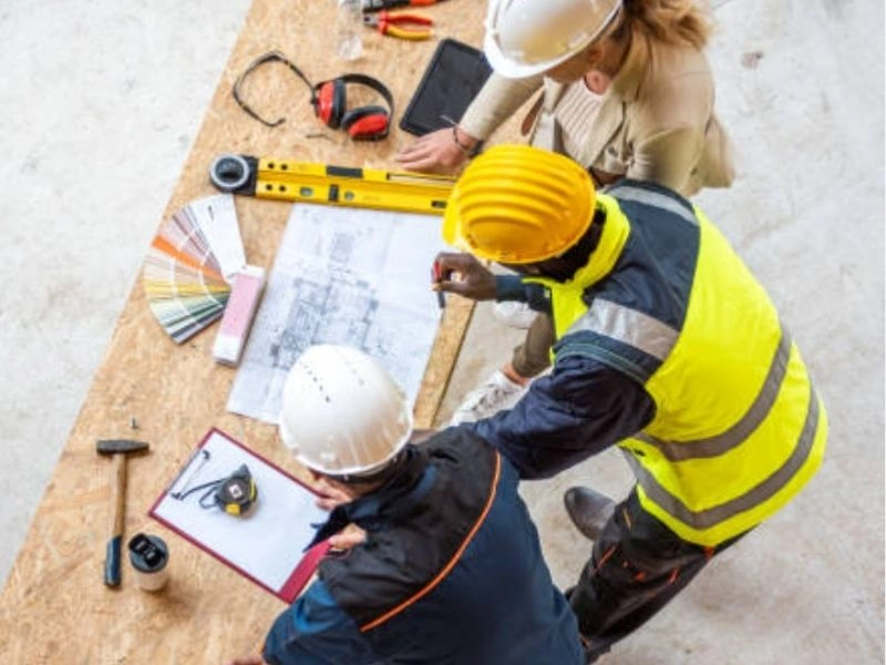 Contractor and inspector reviewing plans during a residential ADU inspection