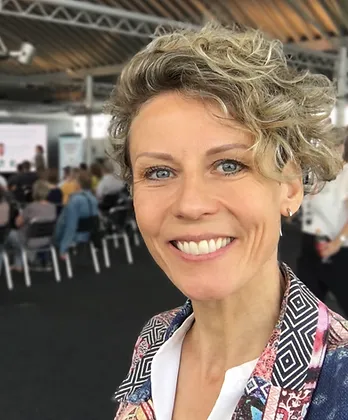 Lächelnde Frau mit blonden, kurzen Locken