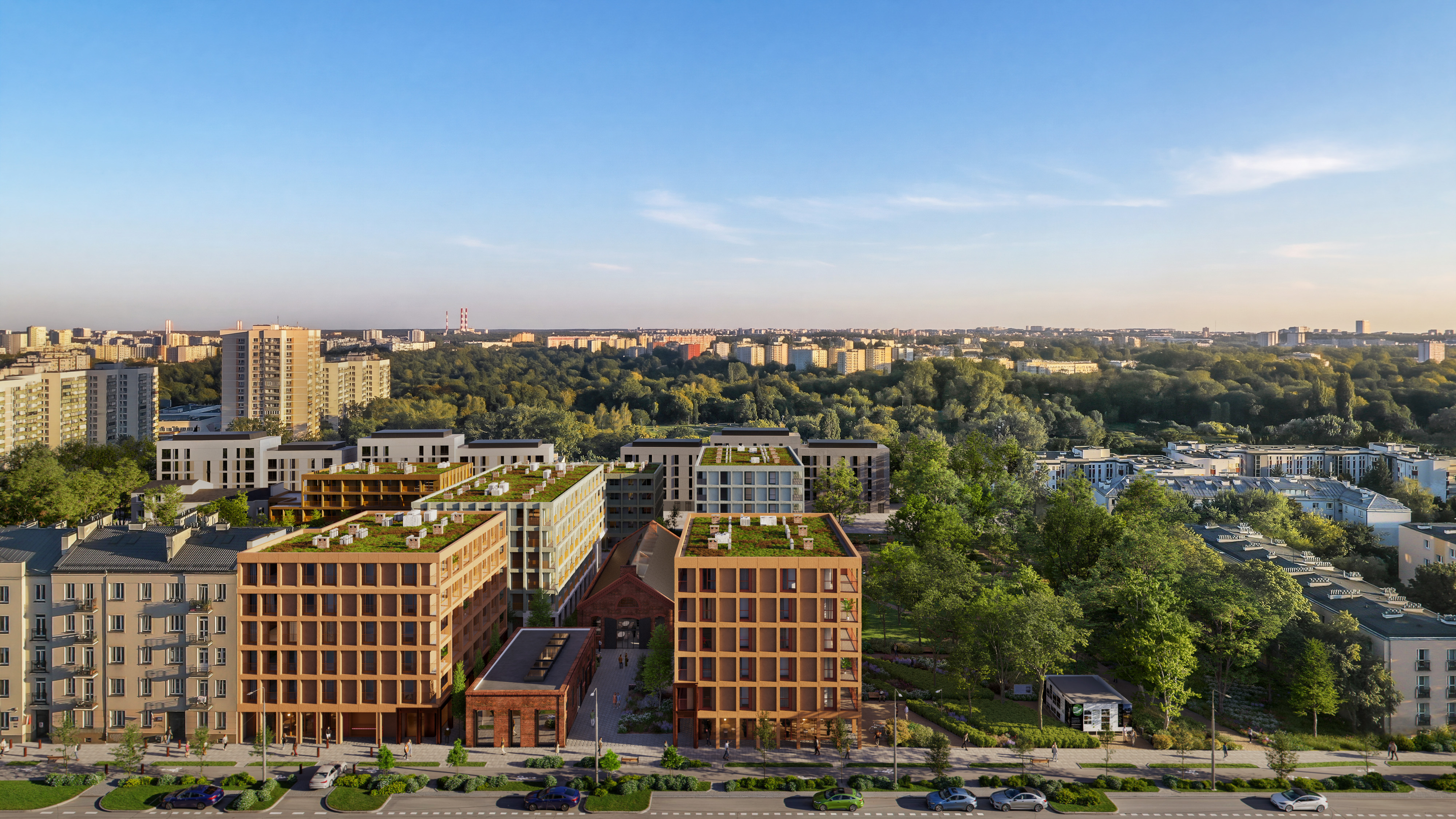 Współczesny kompleks mieszkaniowo-biurowy z zielonymi dachami, historycznym budynkiem z czerwonej cegły i parkiem miejskim.