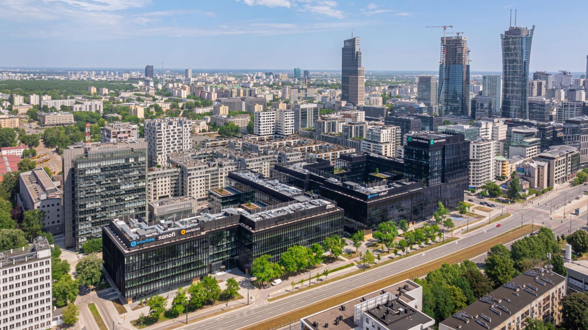 Panorama kompleksu biurowego LIXA z lotu ptaka z ciemnymi przeszklonymi elewacjami i wieżowcami w tle.