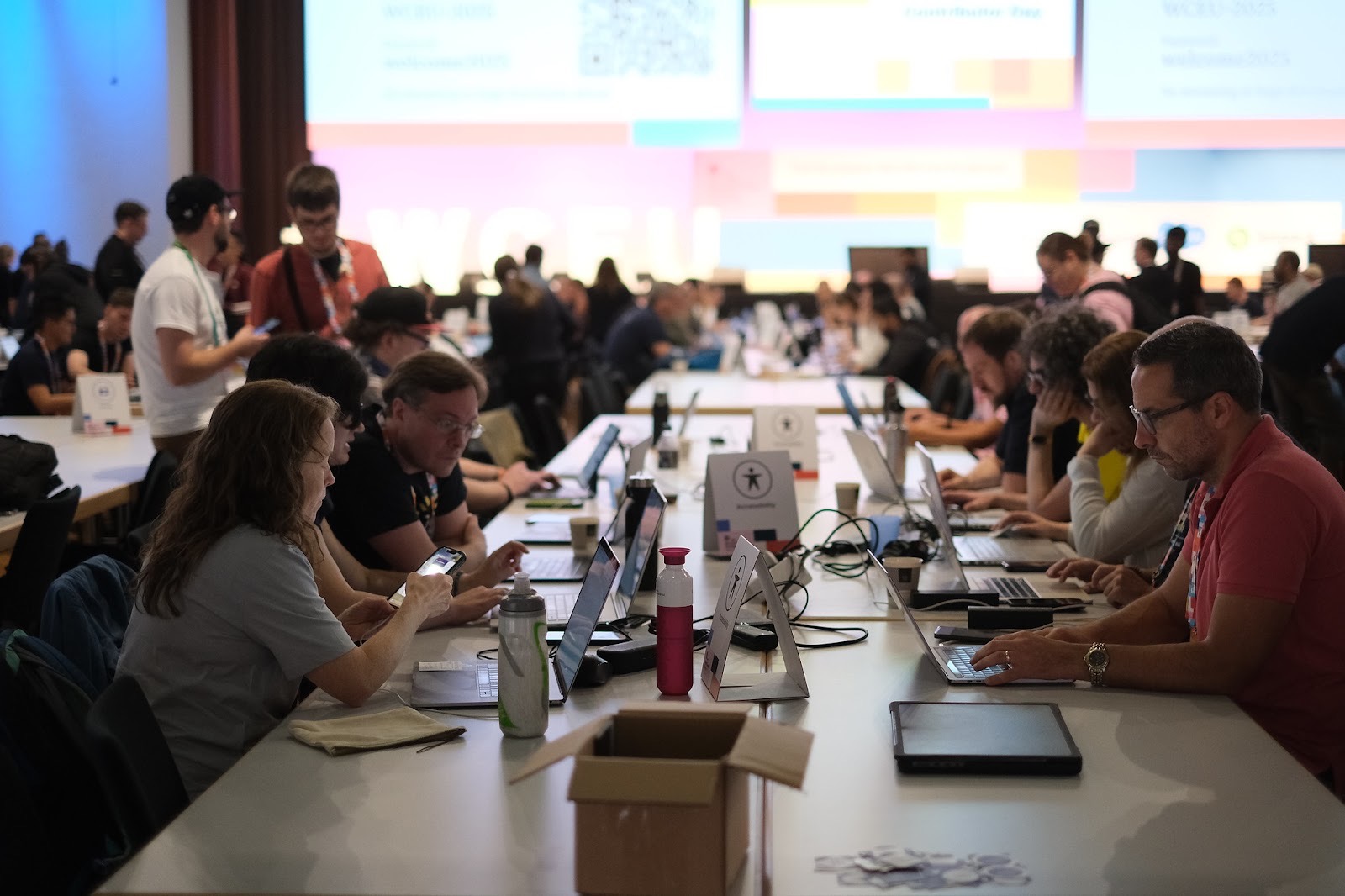 People gathered on a table during WCEU 2025 contributor's day
