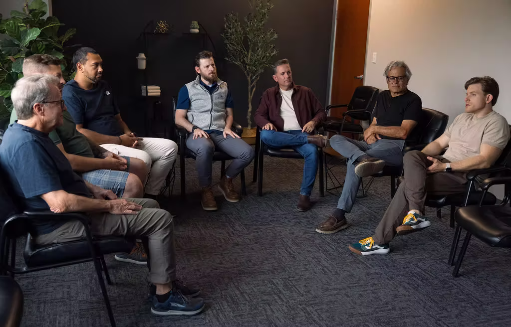A group of men discussion their addiction in therapy