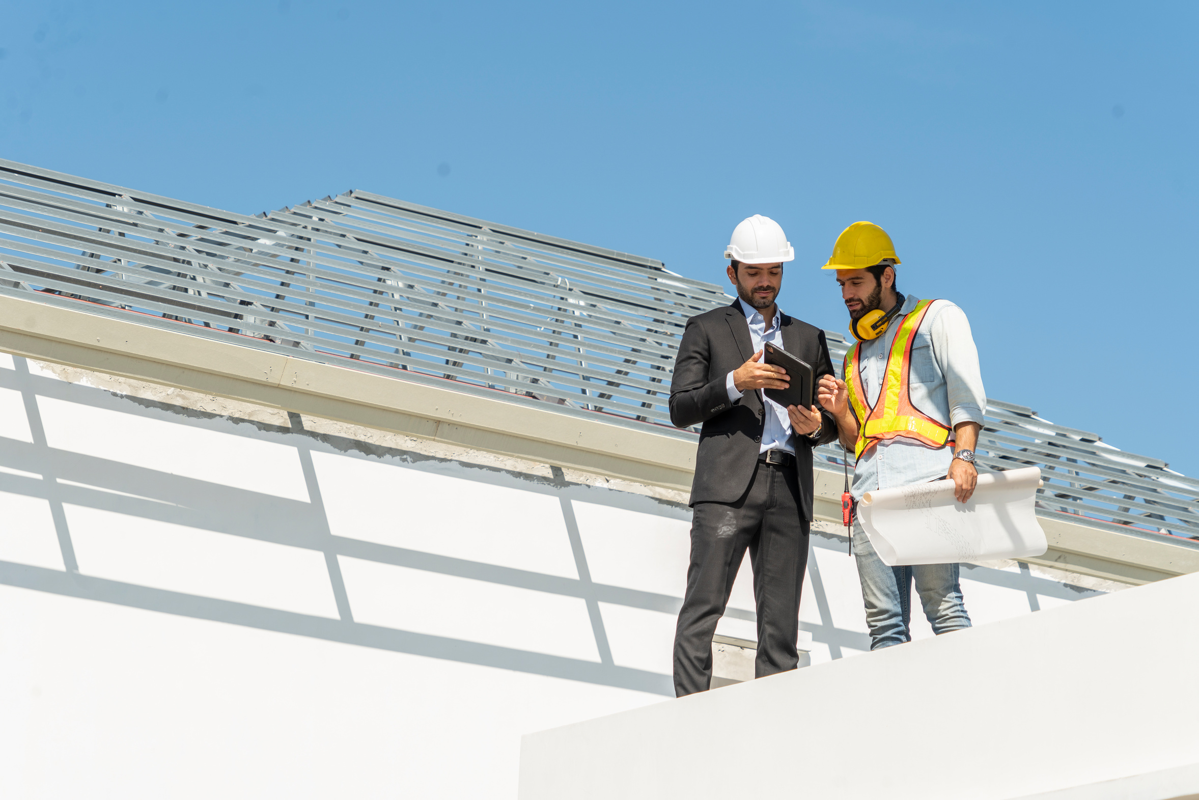 Project managers and contractors reviewing drawings on site