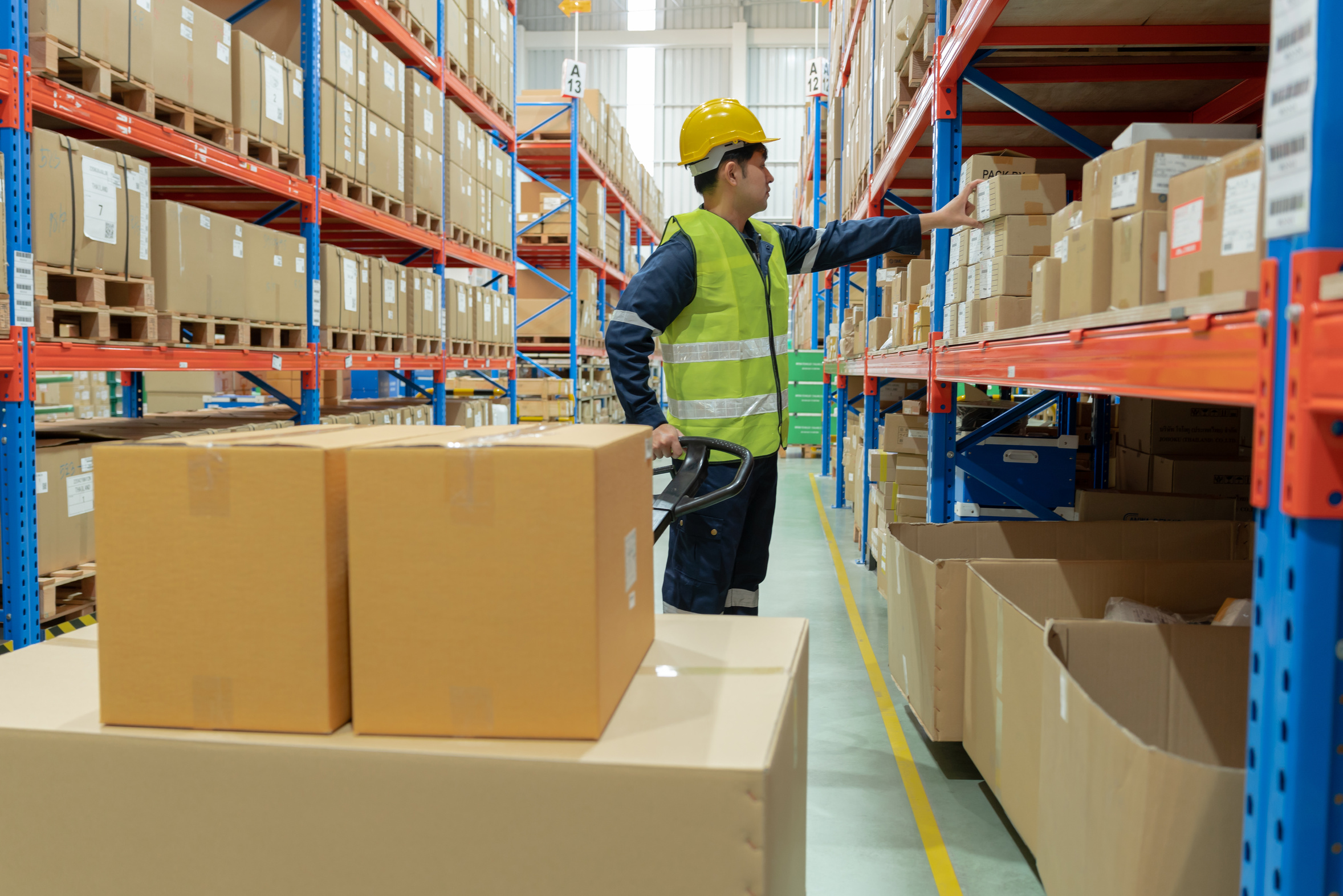 Warehouse worker picking boxed goods from stock
