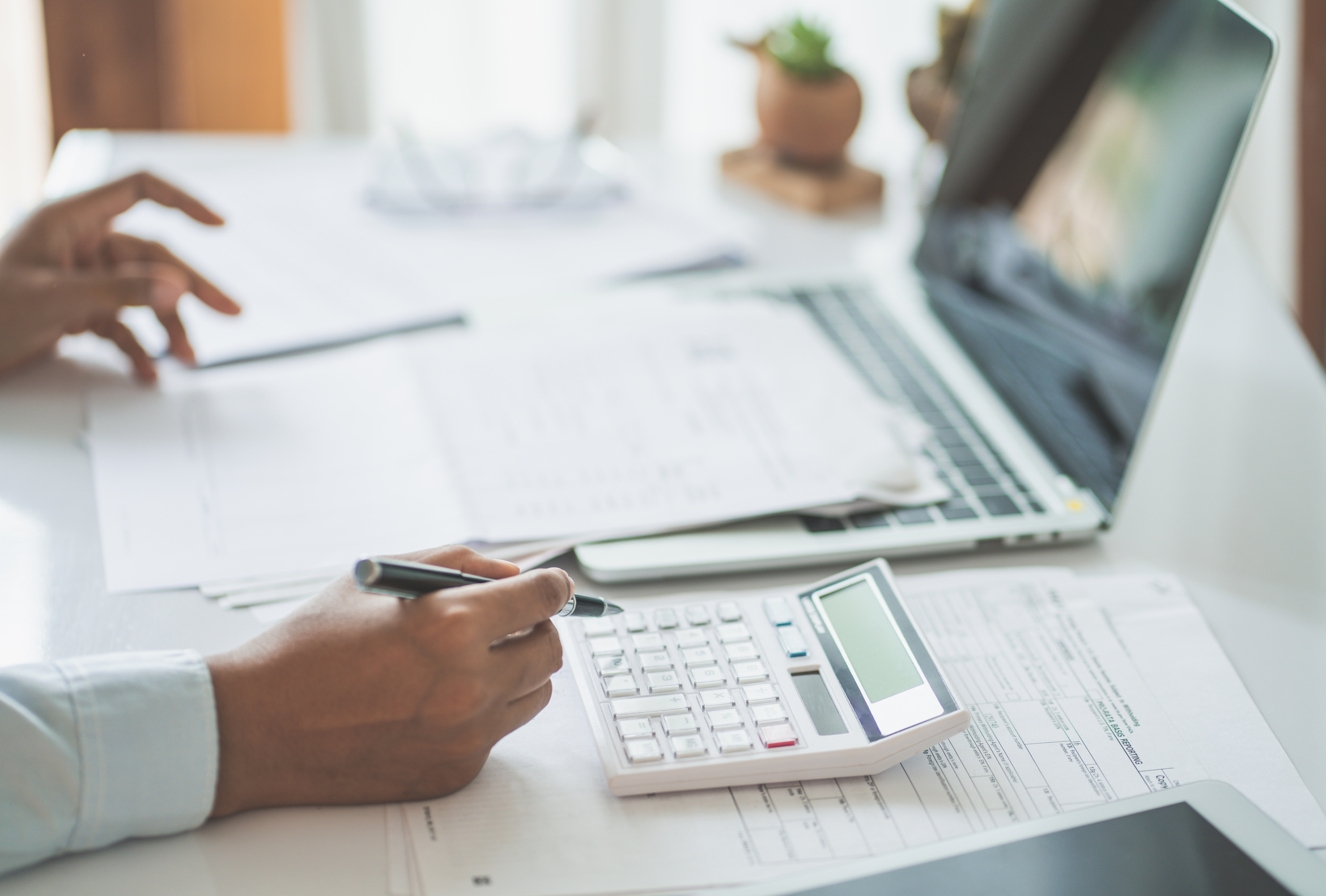 Calculator and paperwork laid out for a tax settlement